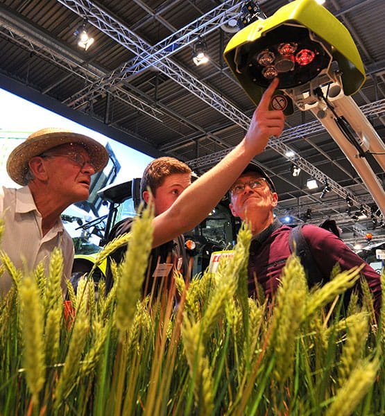 Men observing a heating device for wheat